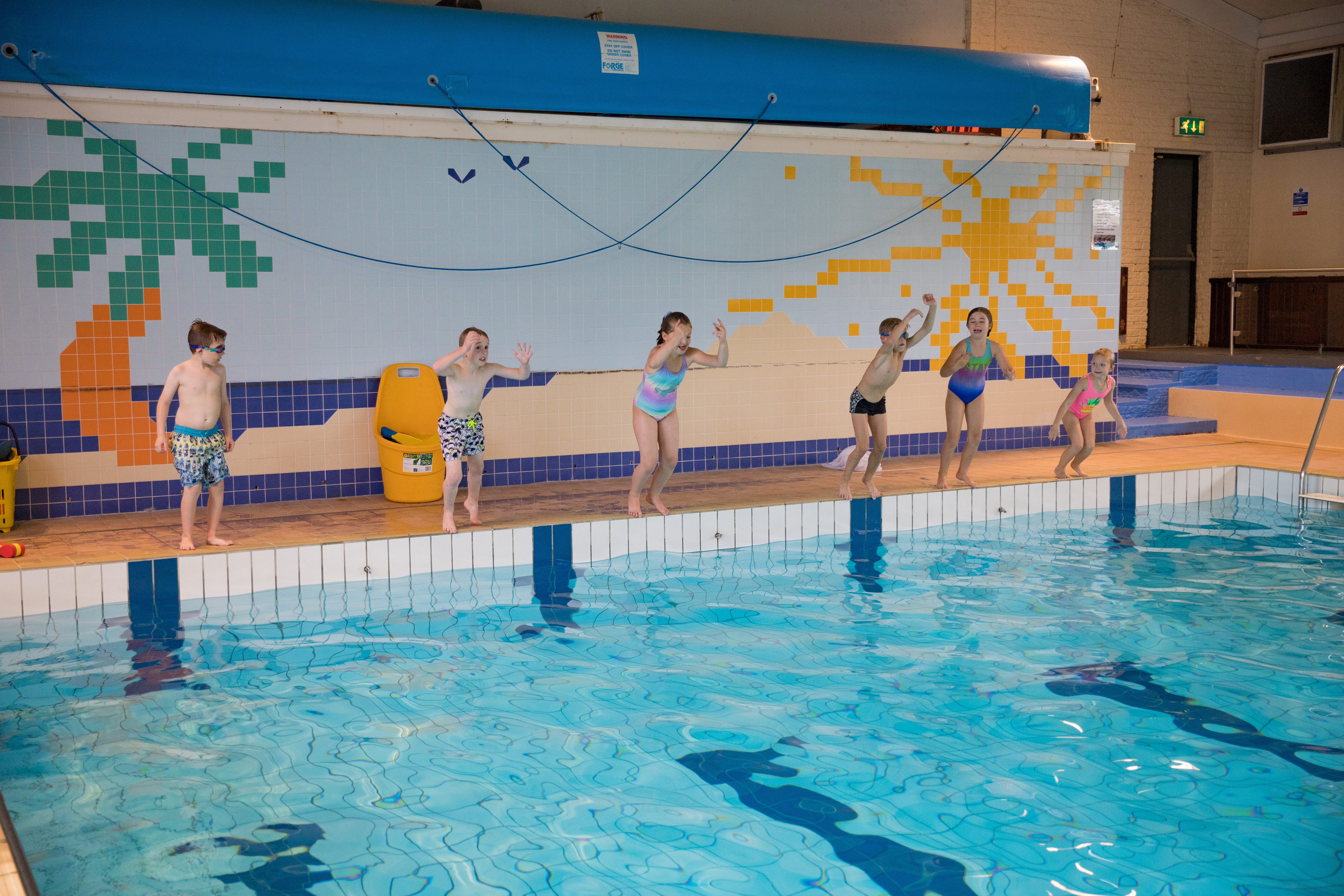 kids jumping in pool