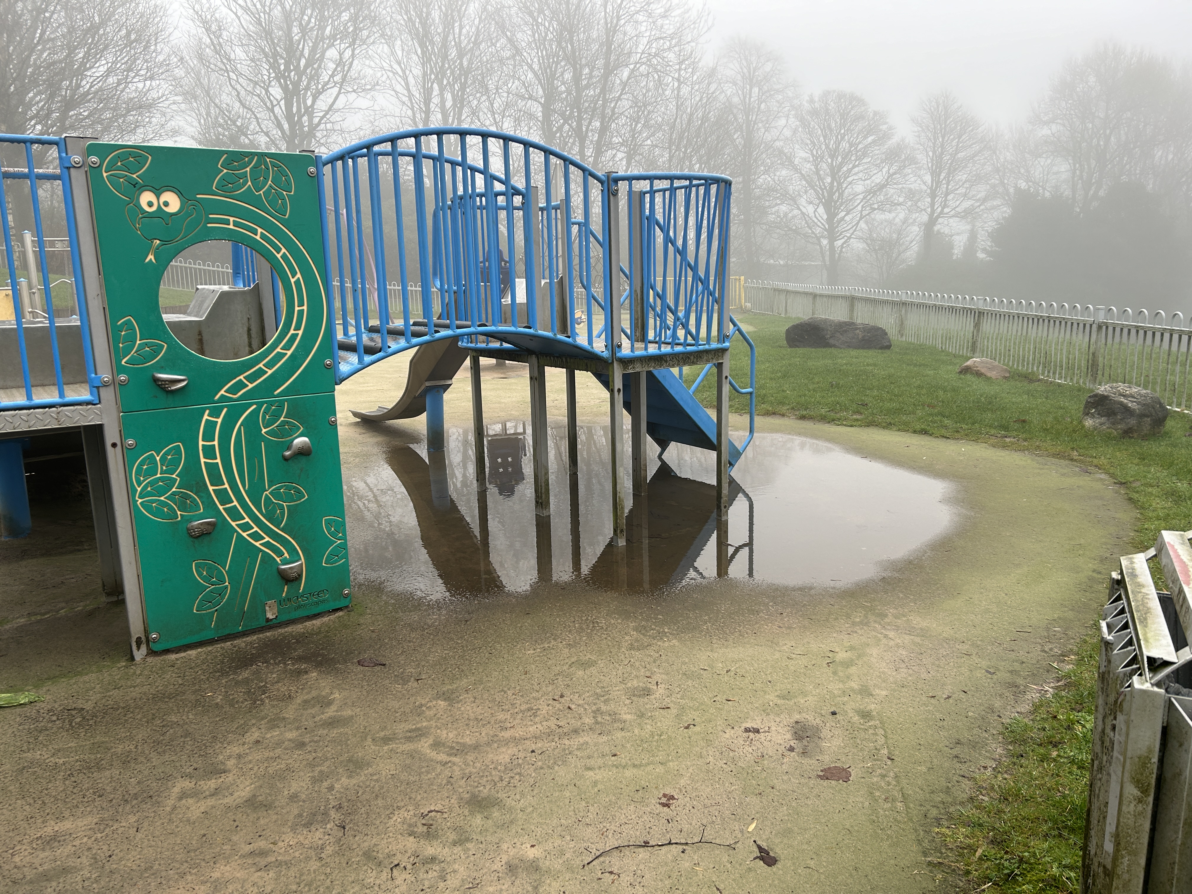 childrens slide and a big puddle