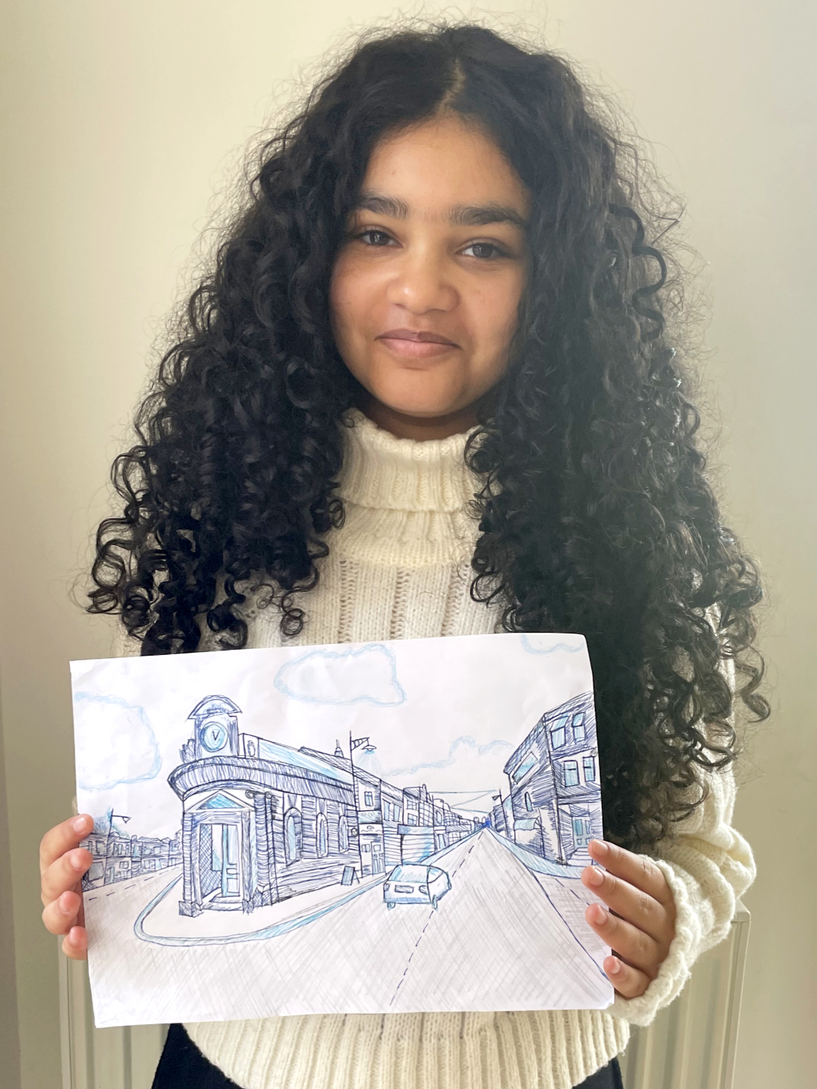 girl holding her hand drawn sketch
