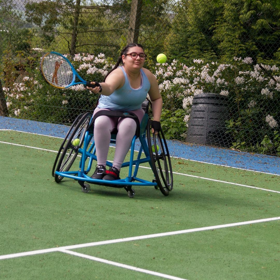 Wheelchair user playing tennis people
